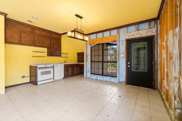 kitchen with white appliances, decorative light fixtures, and sink