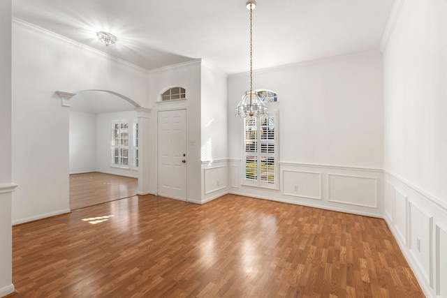 interior space featuring ornate columns, a wealth of natural light, and crown molding