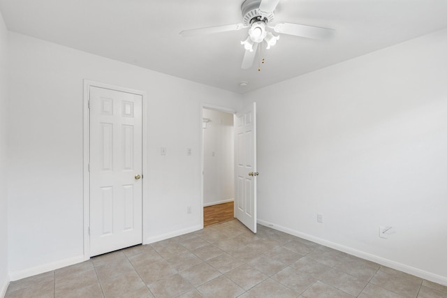 unfurnished bedroom with ceiling fan and light tile patterned flooring