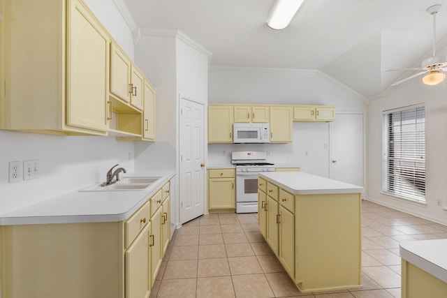 kitchen with sink, light tile patterned floors, lofted ceiling, white appliances, and a kitchen island