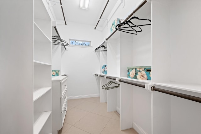 spacious closet with light tile patterned floors