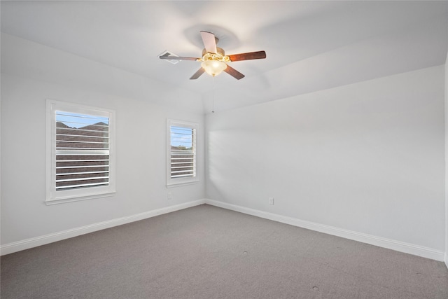 carpeted spare room featuring ceiling fan