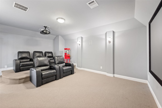 carpeted home theater room with lofted ceiling