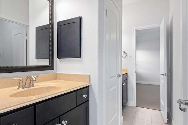 bathroom featuring tile patterned flooring and vanity