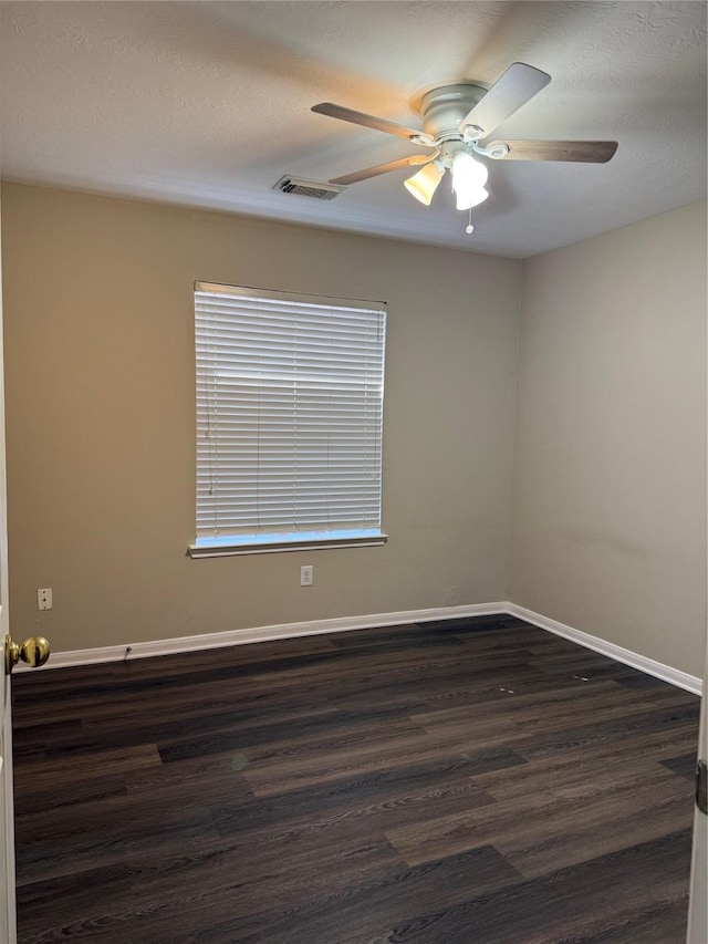 spare room with ceiling fan and dark hardwood / wood-style flooring