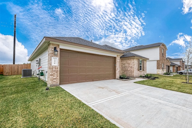 single story home featuring a garage, a front yard, and central AC