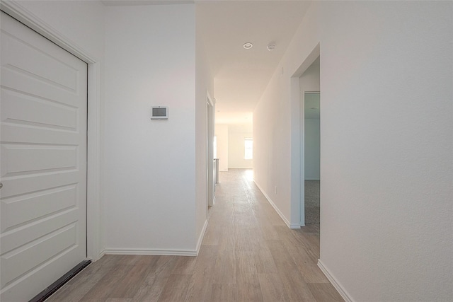 corridor with light wood-type flooring