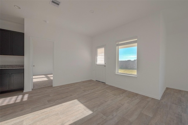 spare room featuring light hardwood / wood-style flooring