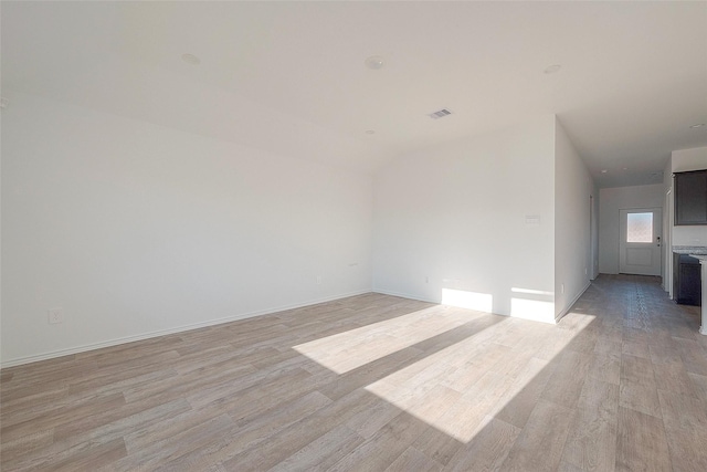 spare room featuring light hardwood / wood-style flooring