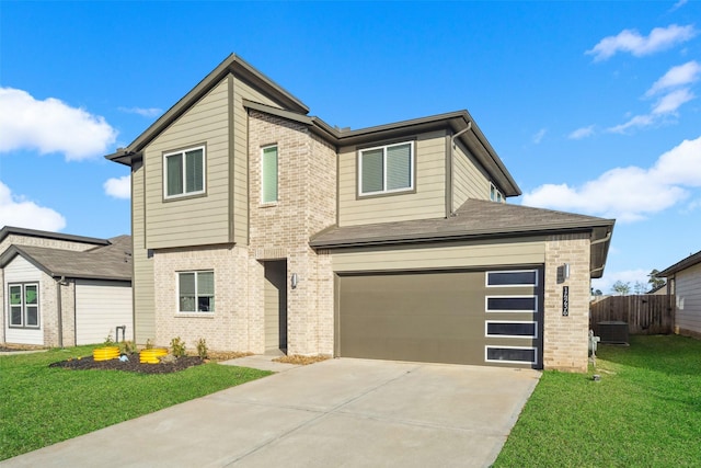 view of front of house with a garage and a front lawn