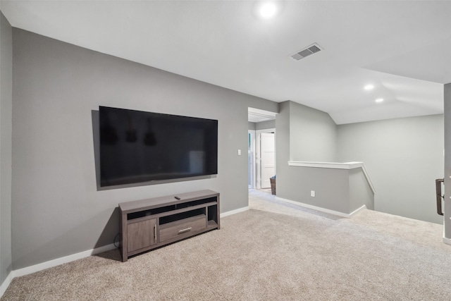 carpeted living room with lofted ceiling