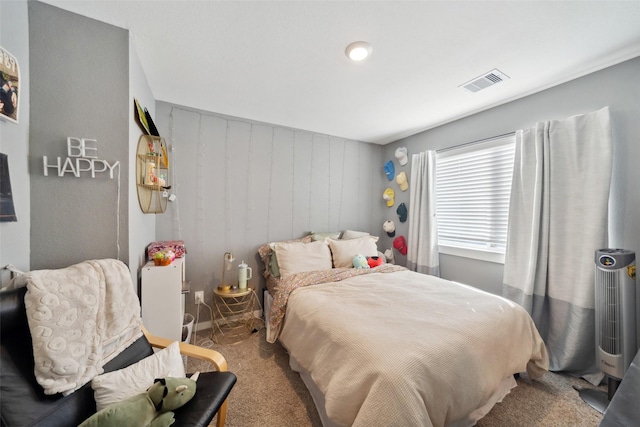 bedroom featuring wood walls and carpet floors