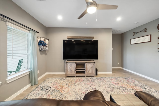 living room with ceiling fan and light hardwood / wood-style floors