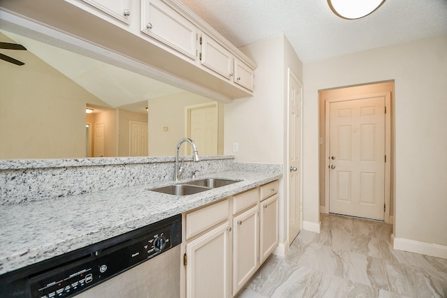 kitchen featuring sink, stainless steel dishwasher, ceiling fan, light stone countertops, and a textured ceiling