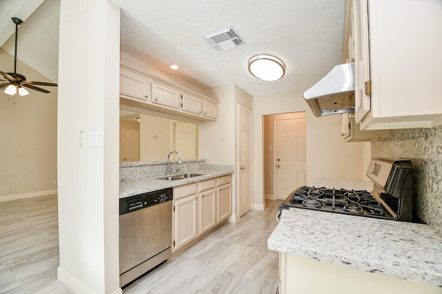 kitchen featuring ventilation hood, sink, ceiling fan, a textured ceiling, and appliances with stainless steel finishes