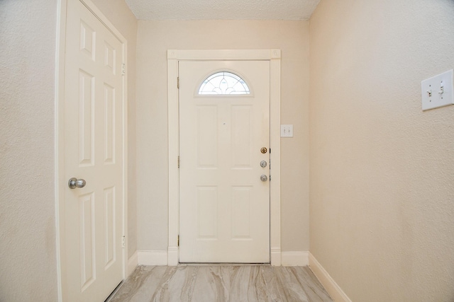 entryway with a textured ceiling