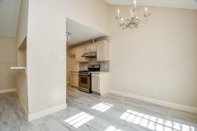 kitchen with backsplash, stainless steel gas range oven, high vaulted ceiling, a notable chandelier, and hanging light fixtures