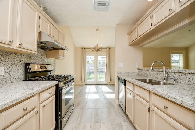 kitchen with french doors, hanging light fixtures, sink, appliances with stainless steel finishes, and a notable chandelier