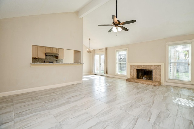 unfurnished living room with beamed ceiling, ceiling fan with notable chandelier, and high vaulted ceiling