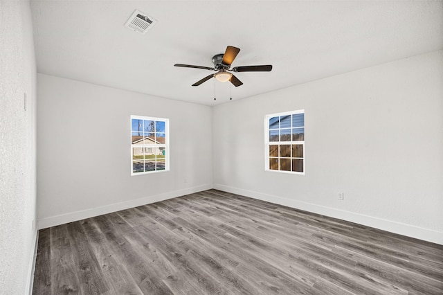 spare room with ceiling fan and hardwood / wood-style flooring