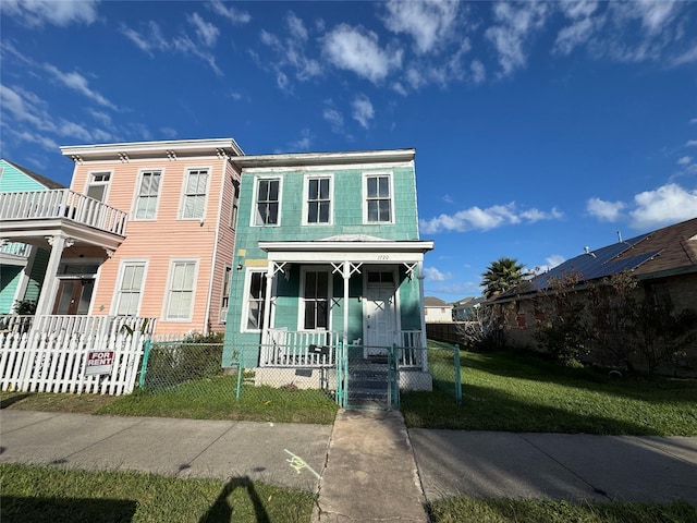 view of front of home with a front lawn and covered porch