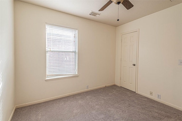 spare room featuring ceiling fan and light colored carpet