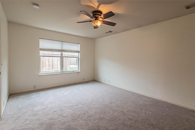 unfurnished room with ceiling fan and light colored carpet