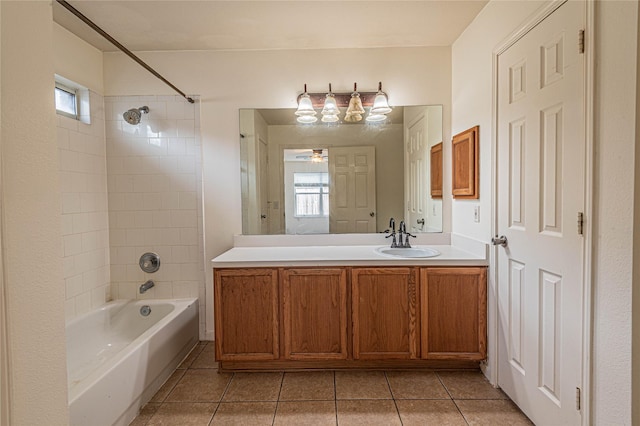 bathroom with vanity, tiled shower / bath combo, ceiling fan, and tile patterned flooring