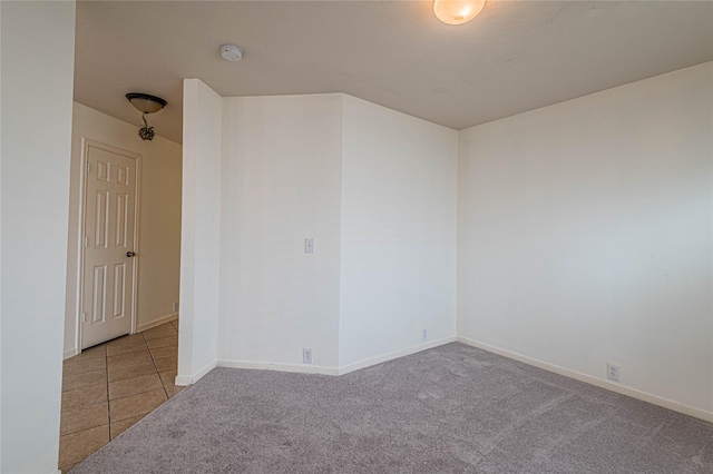 spare room featuring light colored carpet