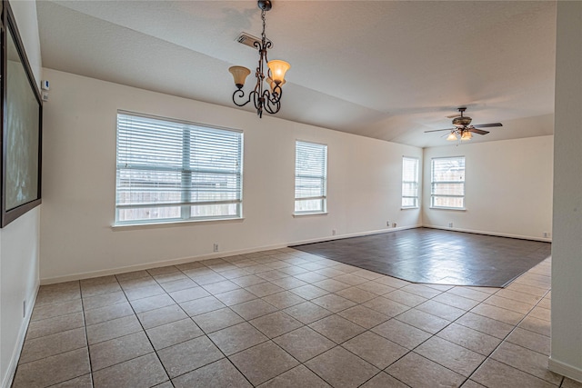 unfurnished room featuring light tile patterned flooring and ceiling fan with notable chandelier