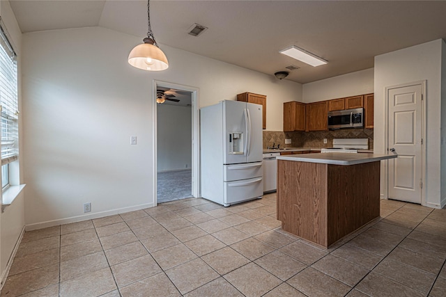 kitchen with a center island, hanging light fixtures, tasteful backsplash, white appliances, and light tile patterned flooring