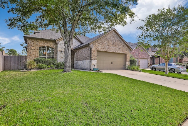 view of front of house featuring a front yard and a garage