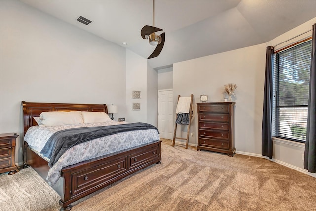 bedroom with ceiling fan, light colored carpet, and lofted ceiling