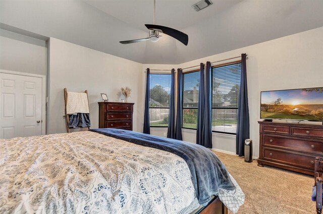 carpeted bedroom featuring ceiling fan and vaulted ceiling