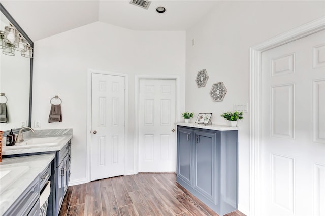 bathroom with vanity and vaulted ceiling