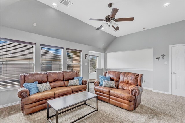 carpeted living room featuring ceiling fan and vaulted ceiling