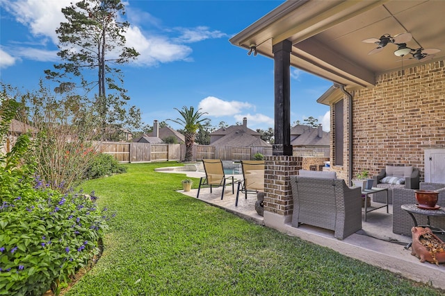 view of yard with ceiling fan and a patio