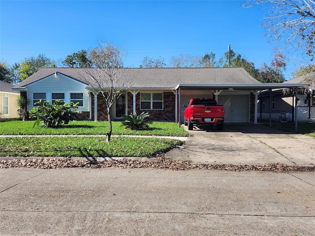 ranch-style house with a front lawn, a garage, and a carport