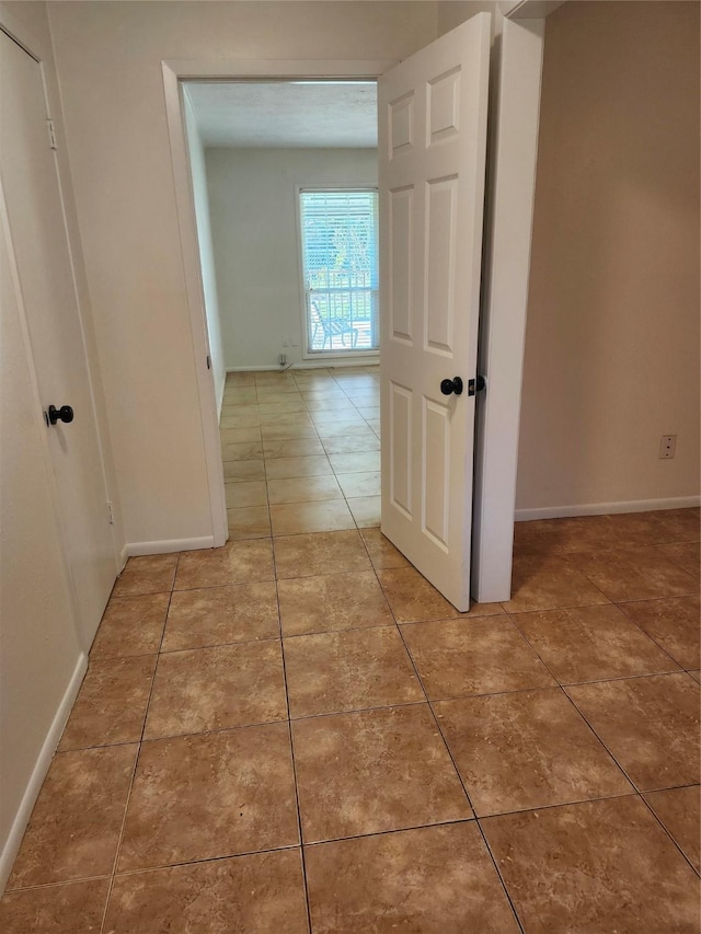 hallway with tile patterned floors