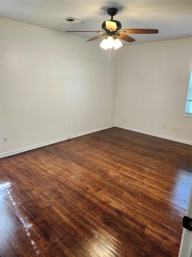 empty room featuring dark hardwood / wood-style flooring and ceiling fan