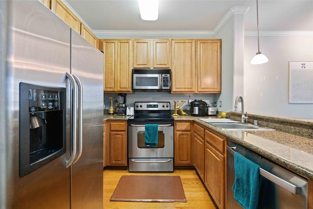 kitchen featuring light stone countertops, pendant lighting, stainless steel appliances, sink, and crown molding