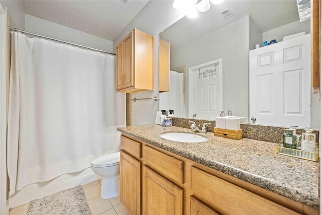 full bathroom with shower / bath combo with shower curtain, toilet, vanity, and tile patterned flooring