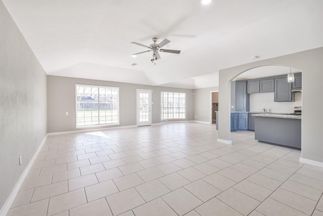 unfurnished living room with light tile patterned floors, ceiling fan, and lofted ceiling