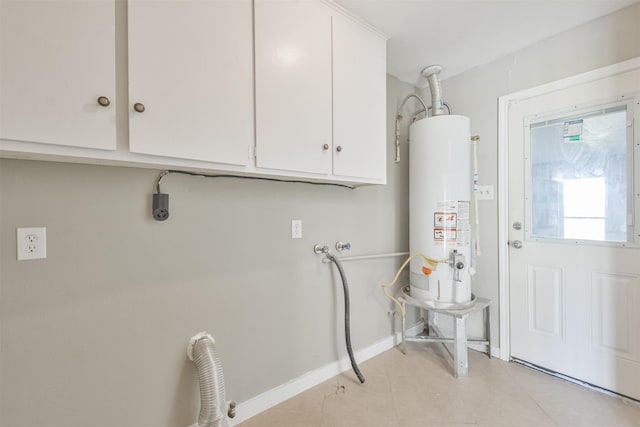 clothes washing area with cabinets, washer hookup, gas water heater, electric dryer hookup, and light tile patterned floors