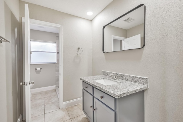 bathroom with tile patterned floors and vanity