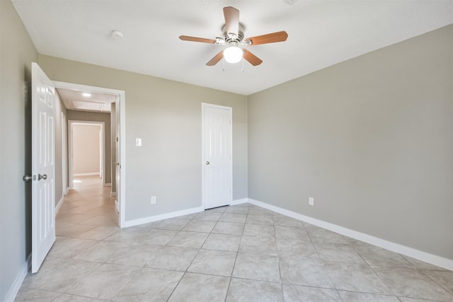 unfurnished bedroom featuring ceiling fan, a closet, and light tile patterned floors