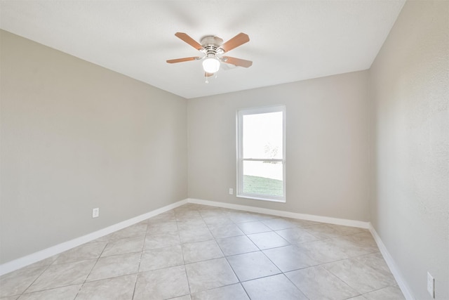 tiled empty room featuring ceiling fan