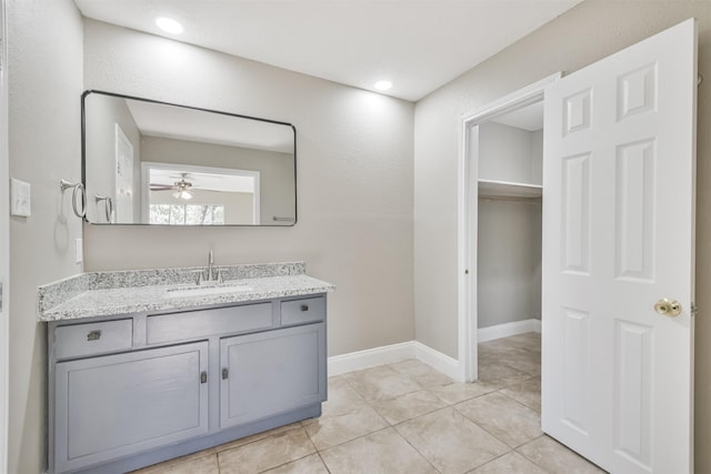 bathroom with tile patterned flooring, ceiling fan, and vanity