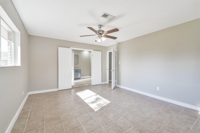 unfurnished bedroom featuring ceiling fan and light tile patterned floors