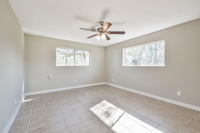 spare room featuring ceiling fan and light tile patterned flooring